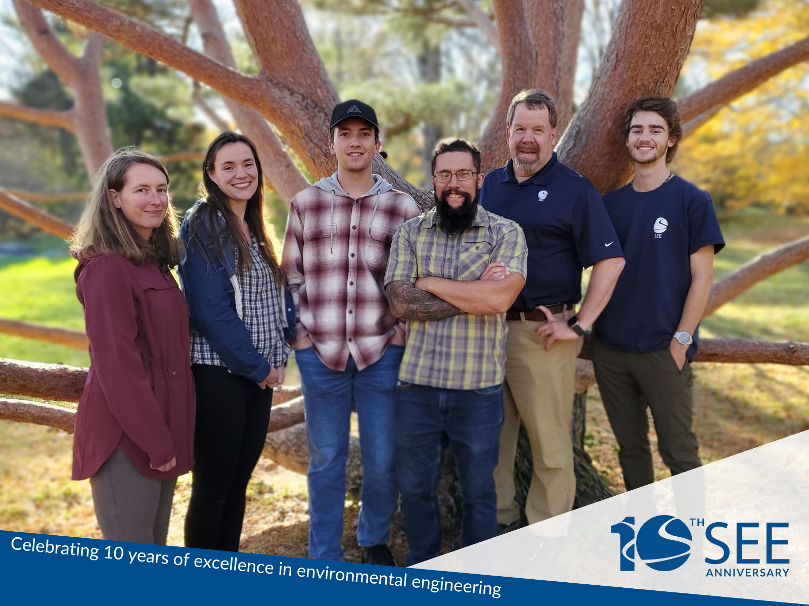 A photo of the Stillwater team in front of a large tree.
