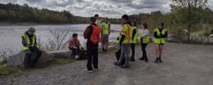 A photo of younger workers gathered along a riverbank