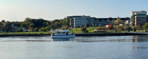 Photo of a large boat on the river in front of the city scape